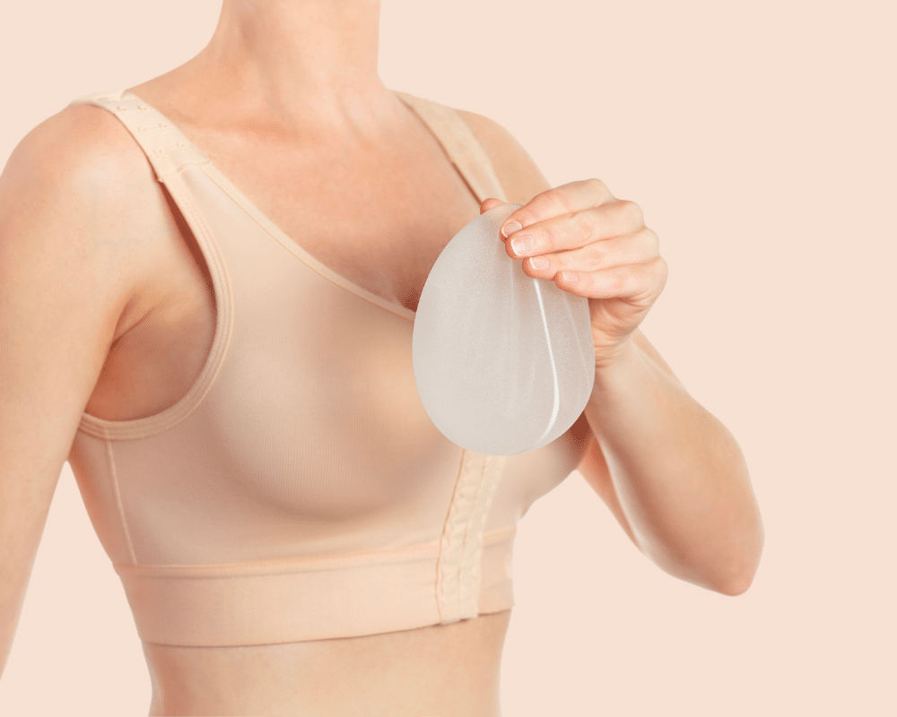 Woman wearing compressing bra which is common after a breast augmentation surgery