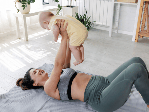 A mom lifting her child with her arms