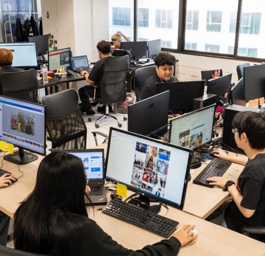 Office employees of a Medical tourism sitting near their desks in the Bangkok's office